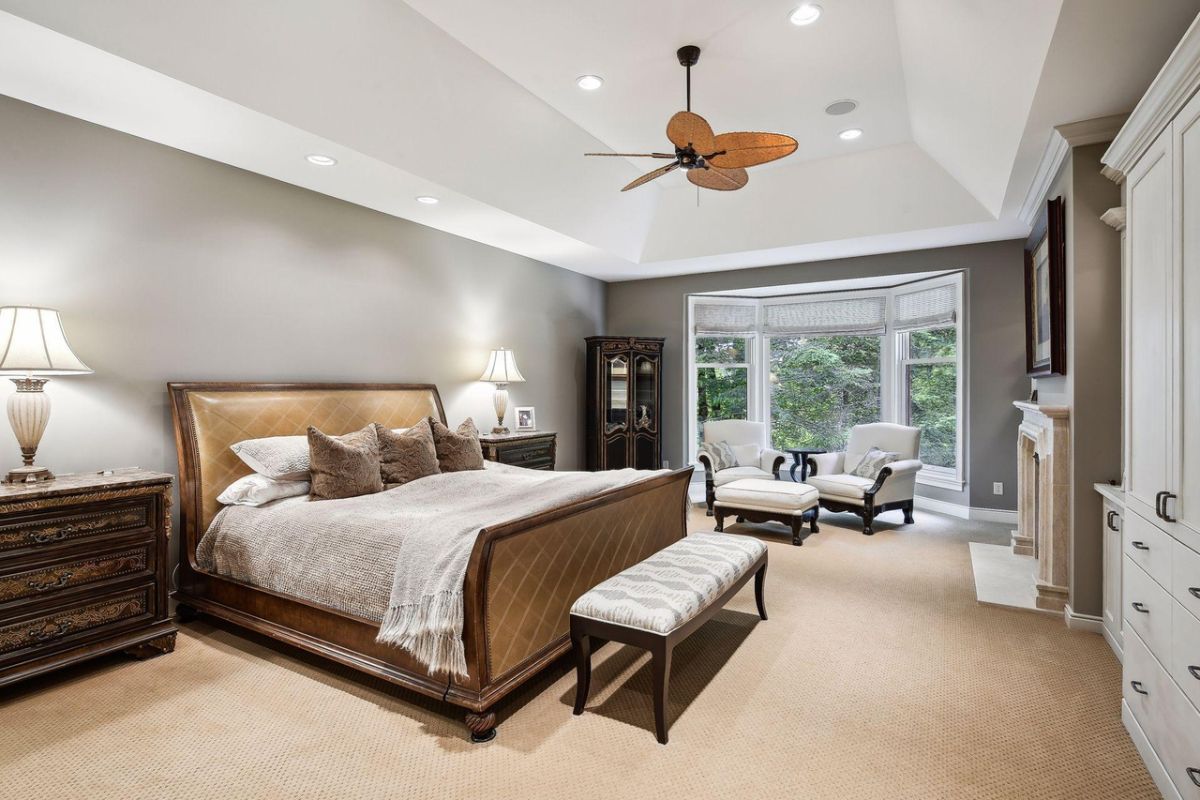 Bedroom with carpet flooring, couches, and custom lighting.