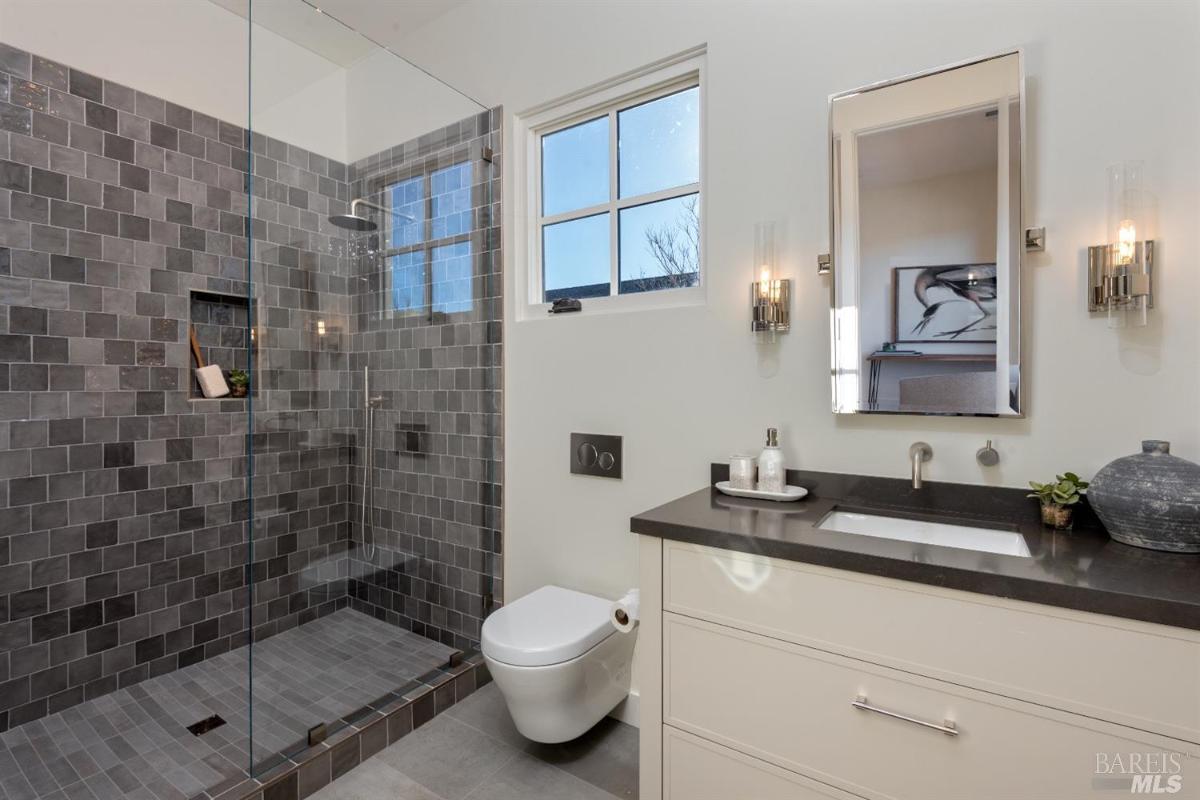 Bathroom with a sink, toilet and shower.