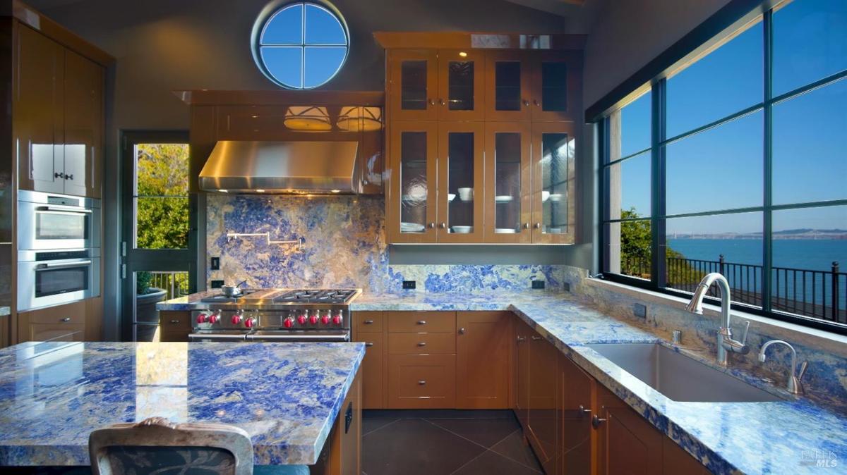 Kitchen with glass windows overlooking the bay.