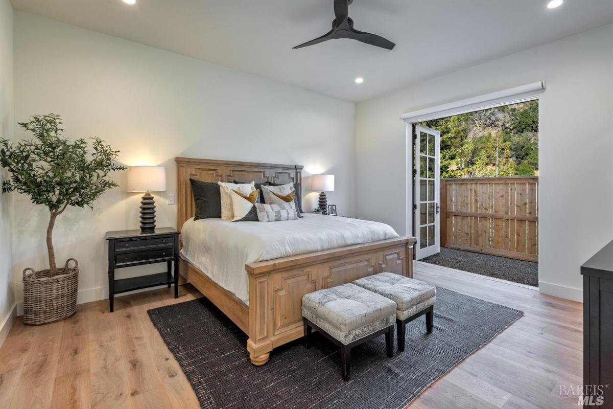 Bedroom with wood flooring and custom lights.