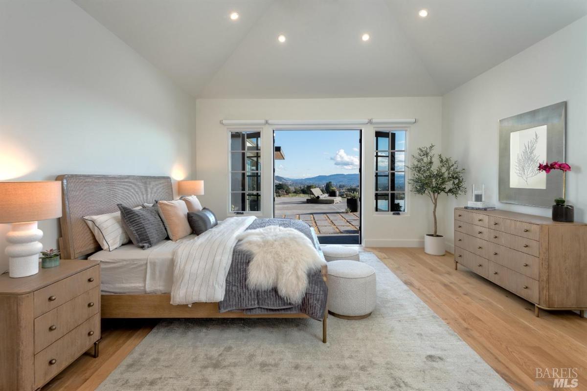 Bedroom with wood flooring and custom lights.