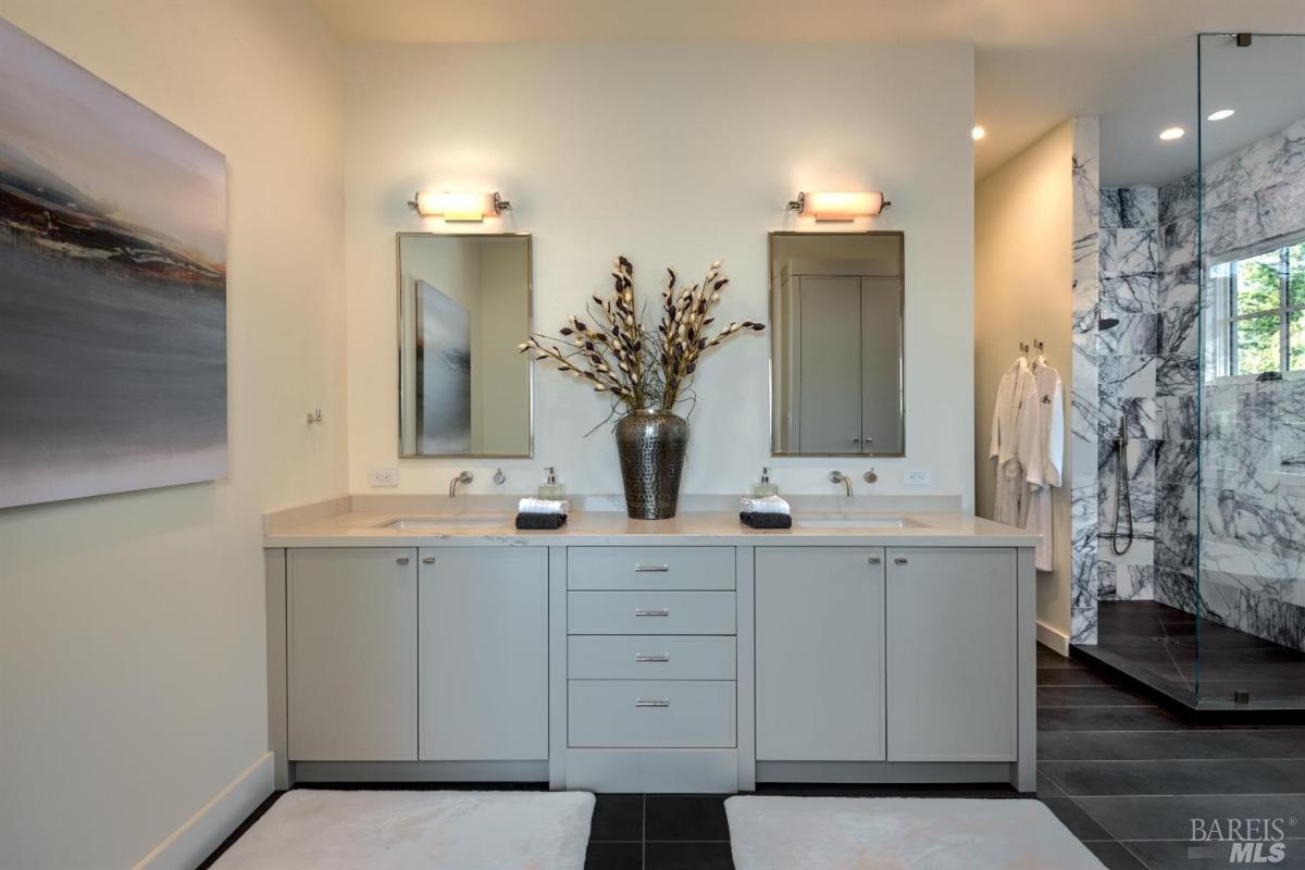 Bathroom with sinks and walk-in shower.