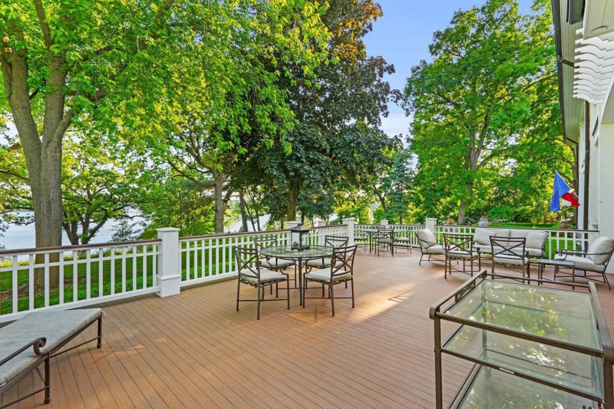 Patio with tables, chairs, and a view of the lake.