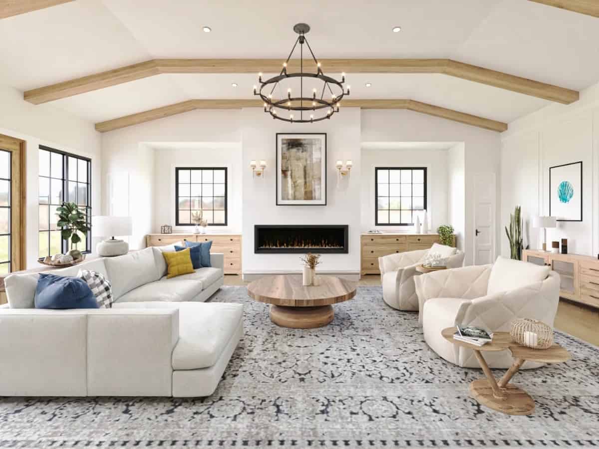 Keeping room with an L-shaped sofa, round-back chairs, a large fireplace, and a vaulted ceiling highlighted by exposed beams.