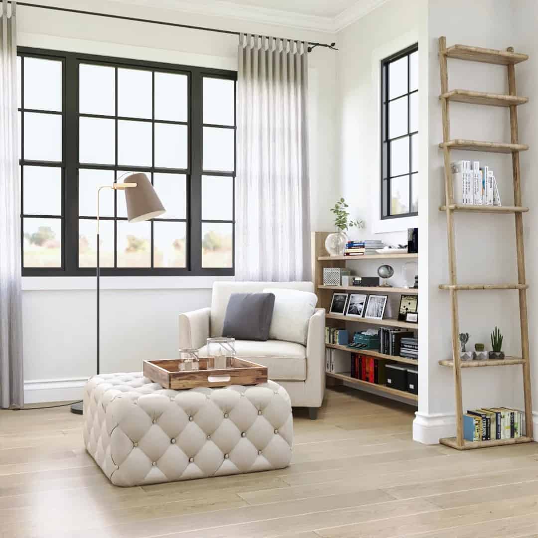 Reading nook with a beige armchair and a tufted ottoman.