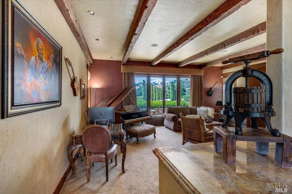 Family room with couches, piano and open beam ceiling.