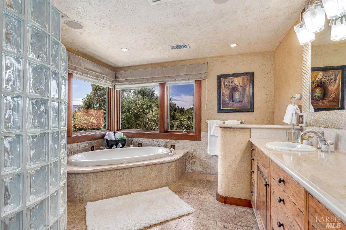 Bathroom with a soaking tub and sink.