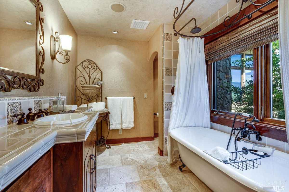 Bathroom with a soaking tub and sink.