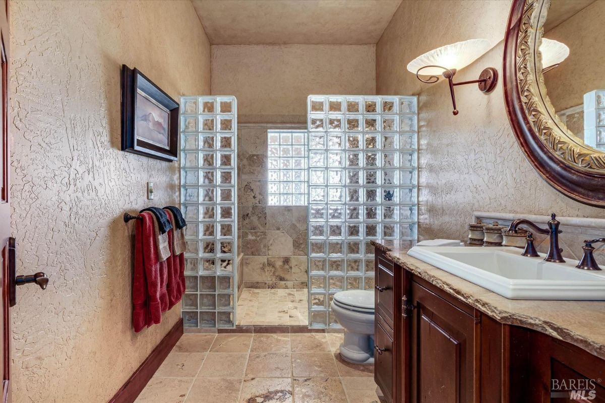 Bathroom with a shower, toilet and sink.