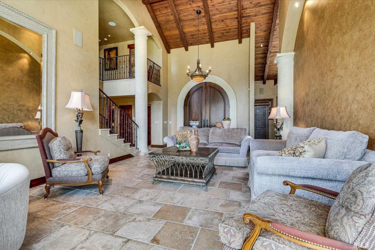 Living room with couches and a chandelier.