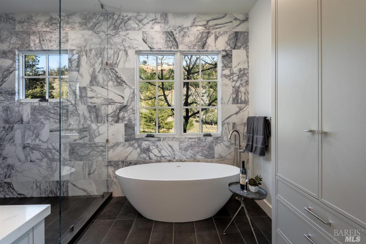 Bathroom with a soaking tub and walk-in shower.