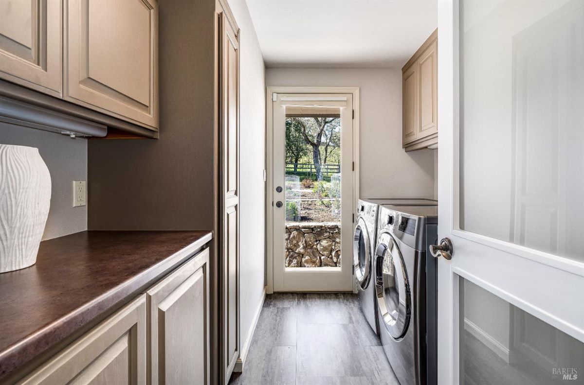 Laundry room with wooden cabinets, a washer and dryer.