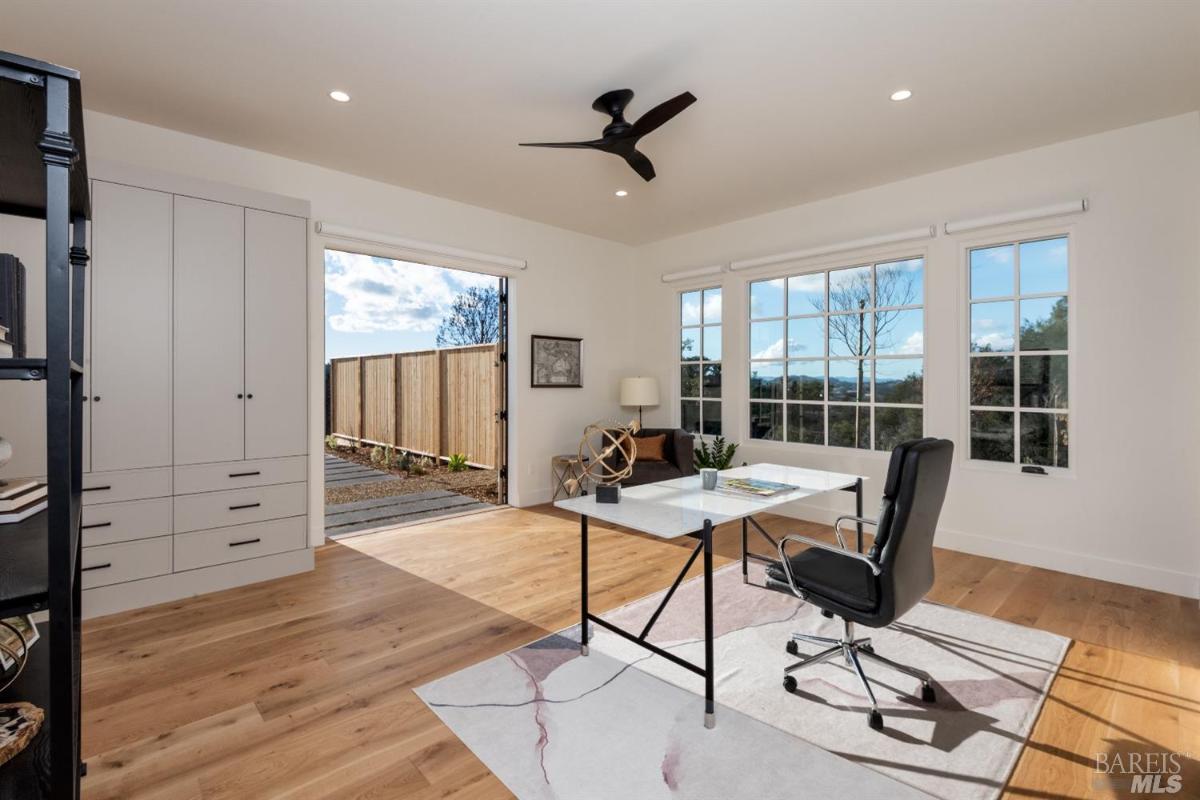 Home office custom lights and wood flooring.