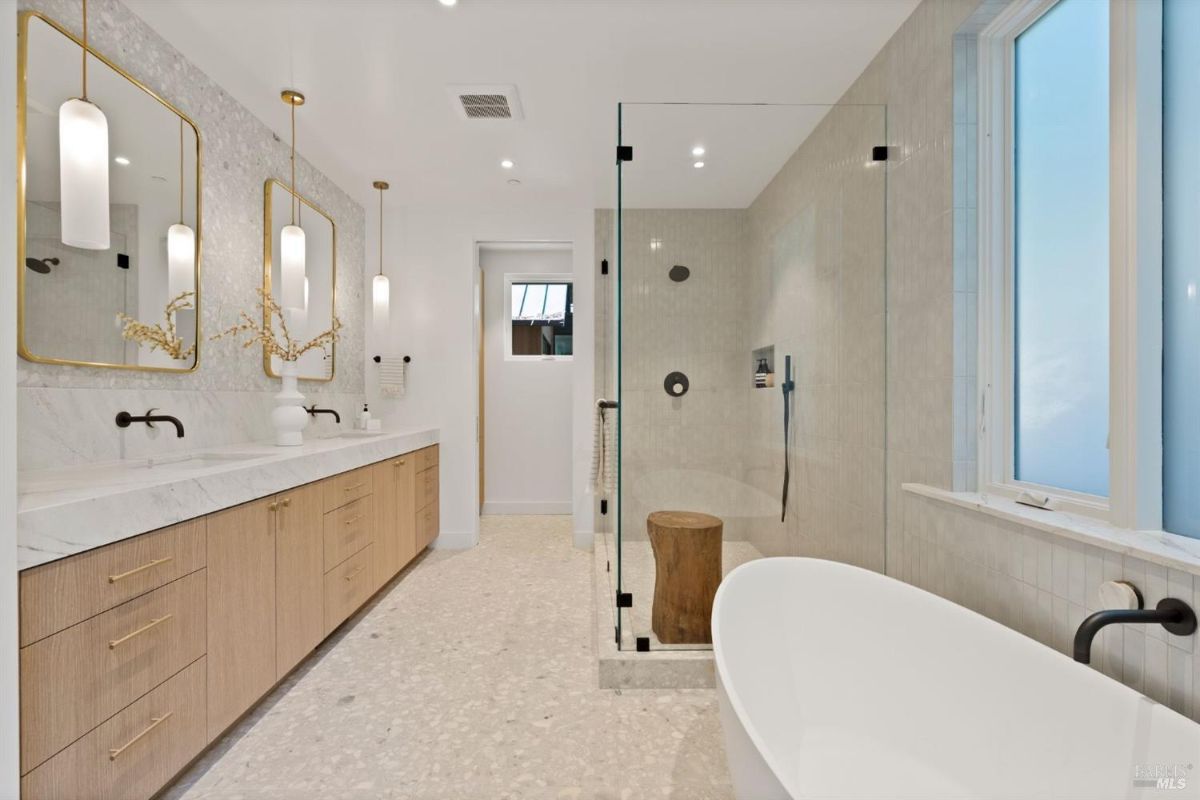 Bathroom with a sink, soaking tub and walk-in shower.