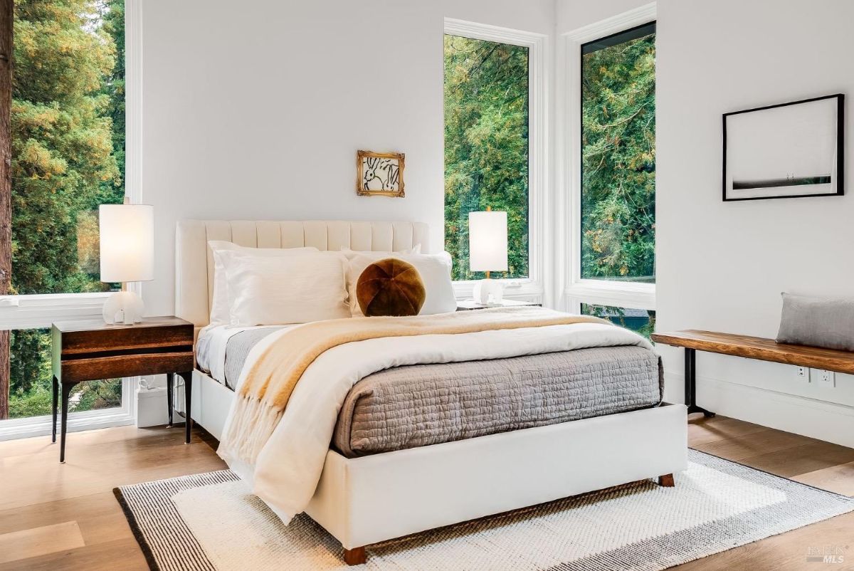 Bedroom with a large bed and glass windows.