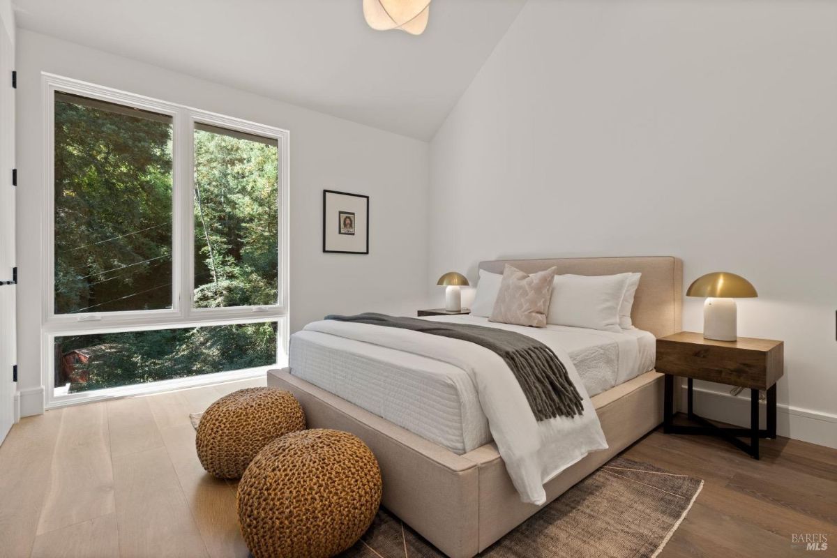 Bedroom with a large bed and glass windows.