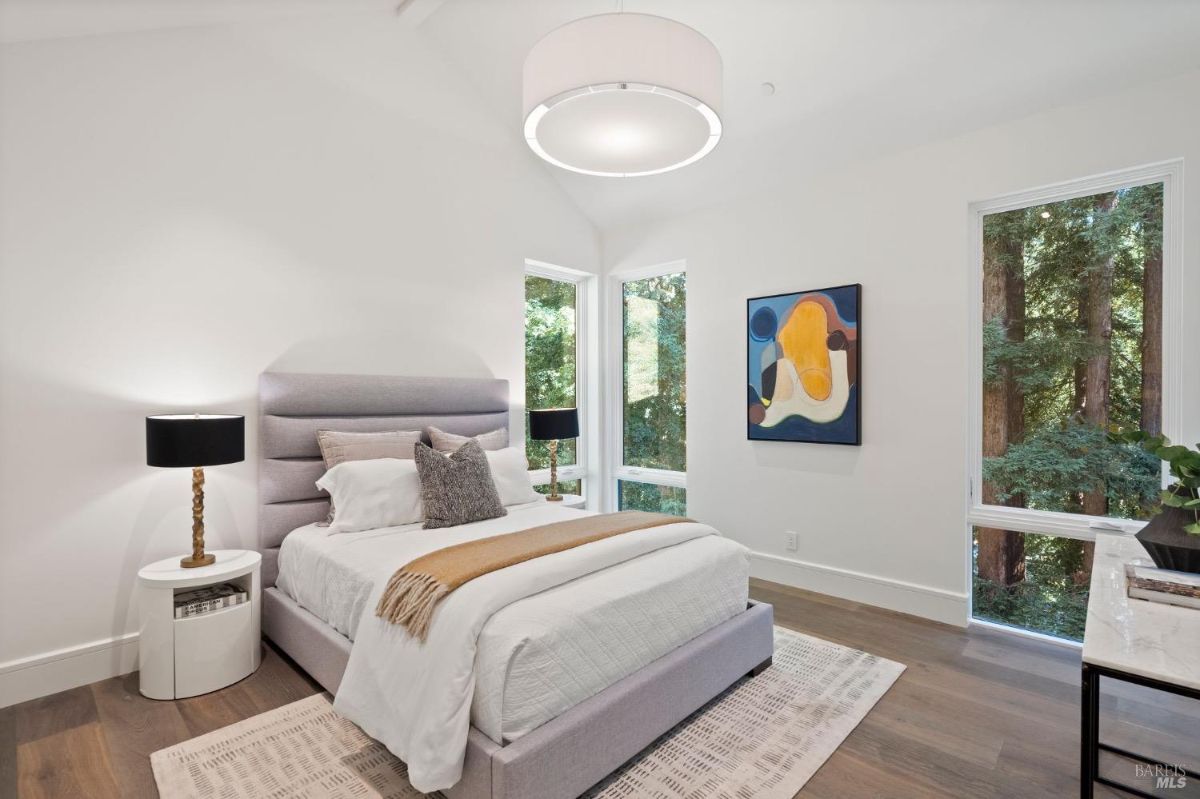 Bedroom with a large bed and glass windows.