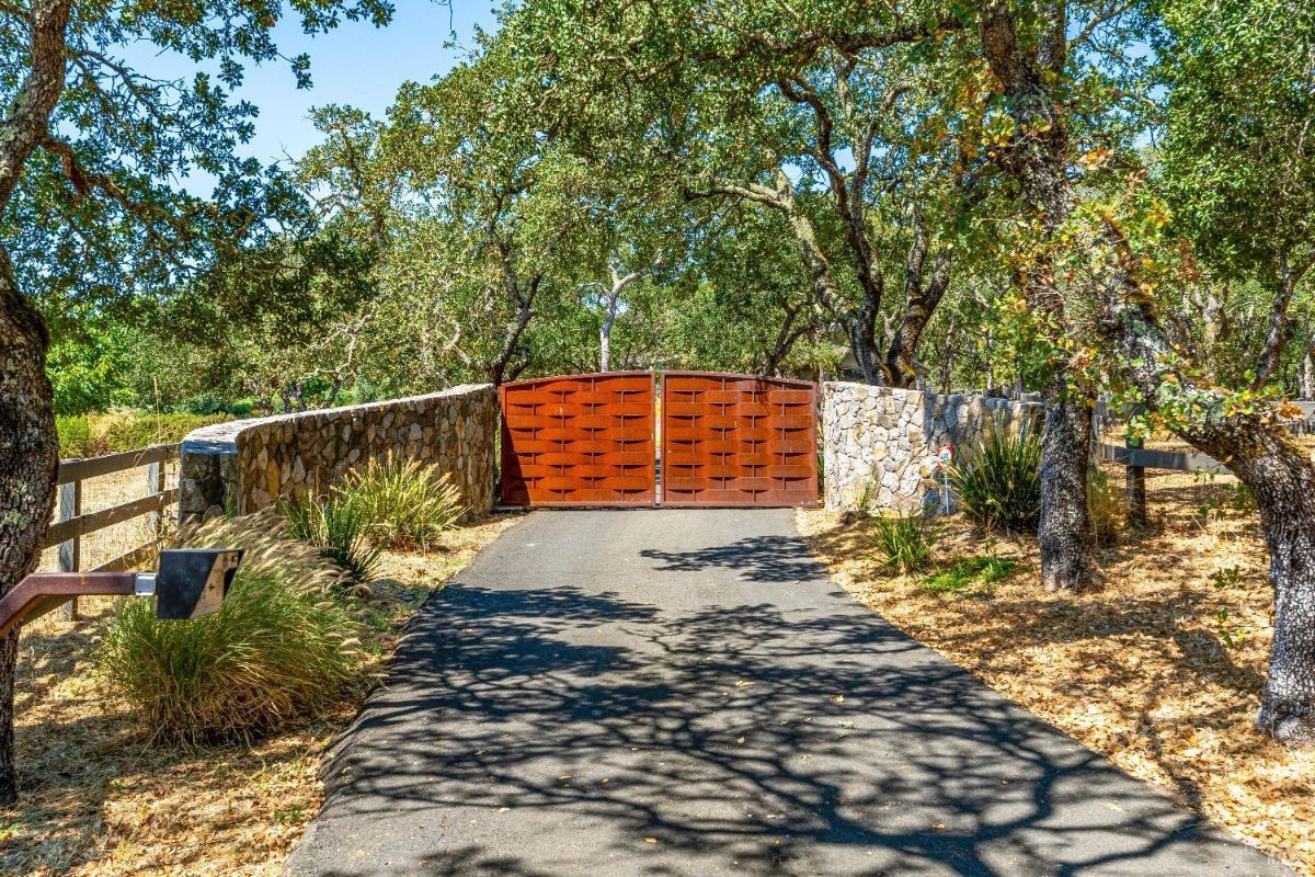 Gate with spacious paved driveway.