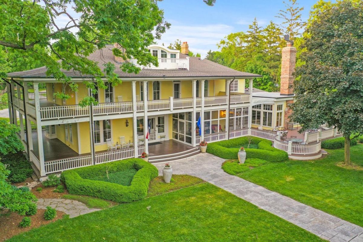 Rear view of the mansion with a spacious backyard.