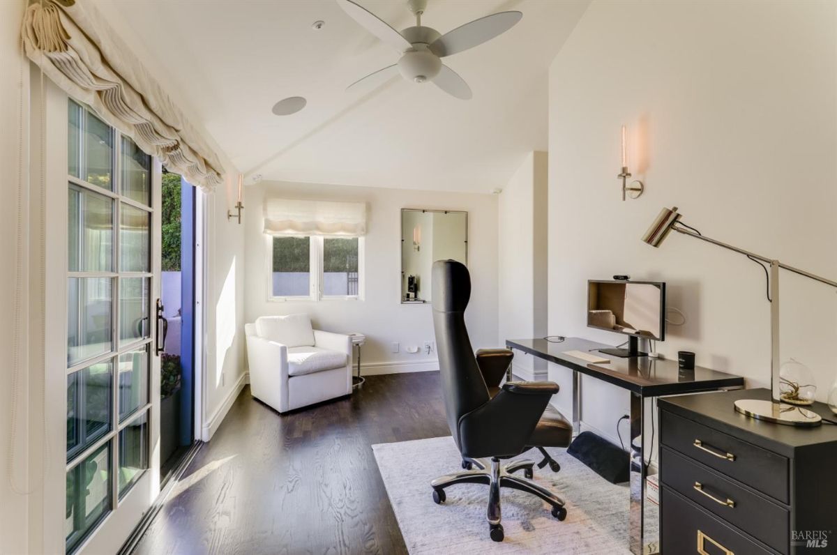 Home office with a computer, desk, office chair and a couch.