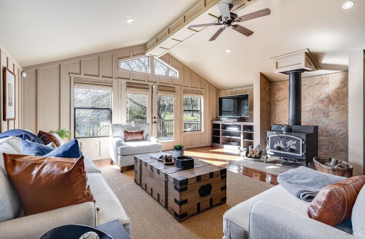 Living room with couches, TV, and a fireplace