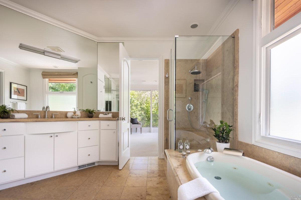 Bathroom with soaking tub, sink and walk-in shower.