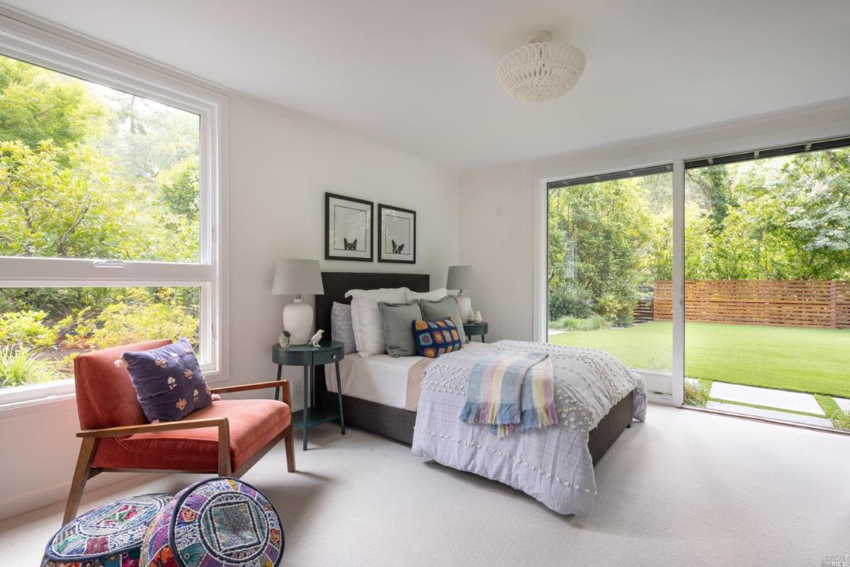 Bedroom with carpet flooring and sliding glass doors.