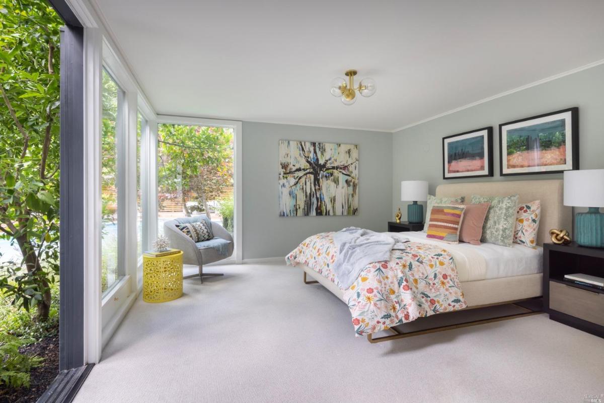 Bedroom with carpet flooring and large glass walls.