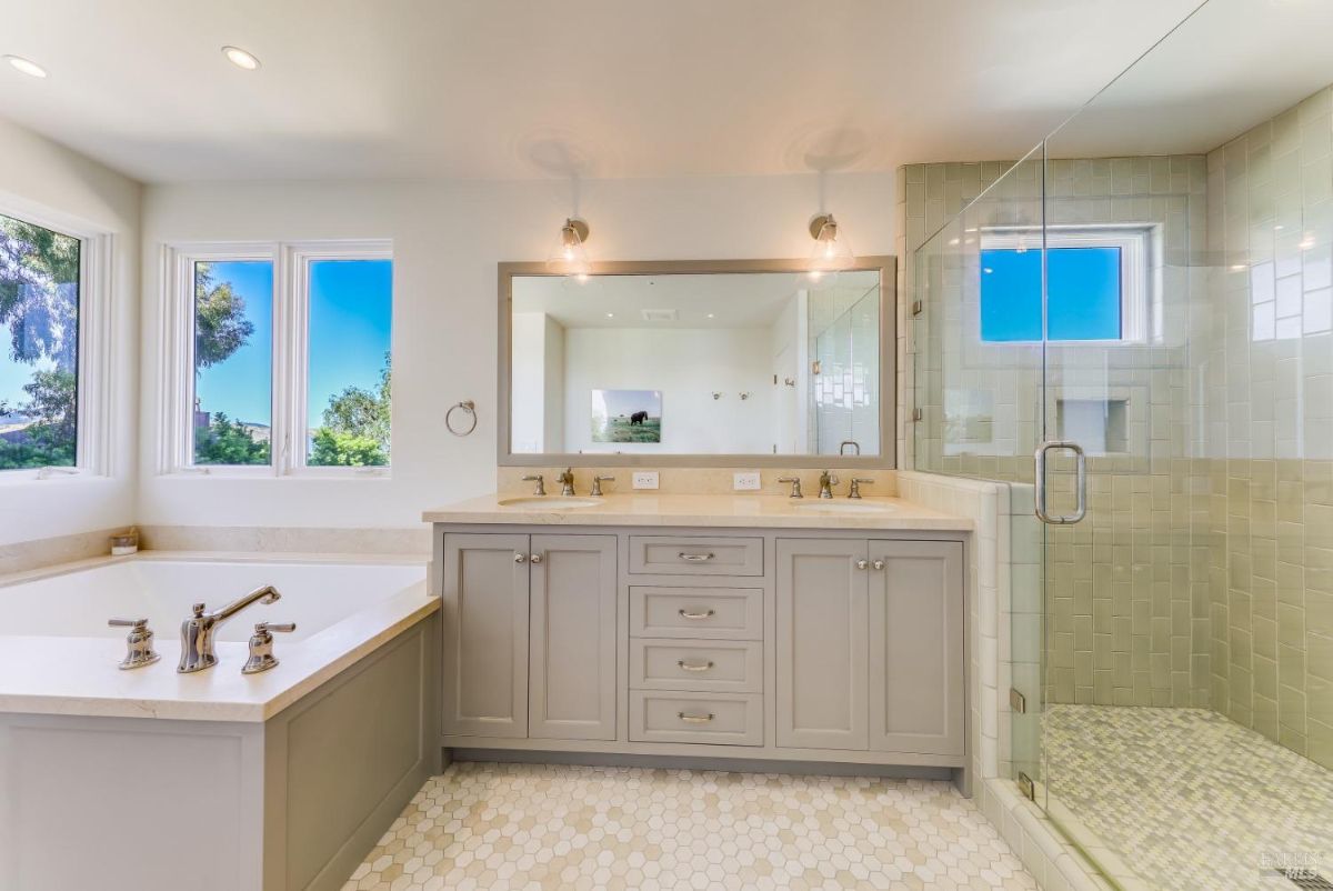 Bathroom with a sink, soaking tub and a shower.