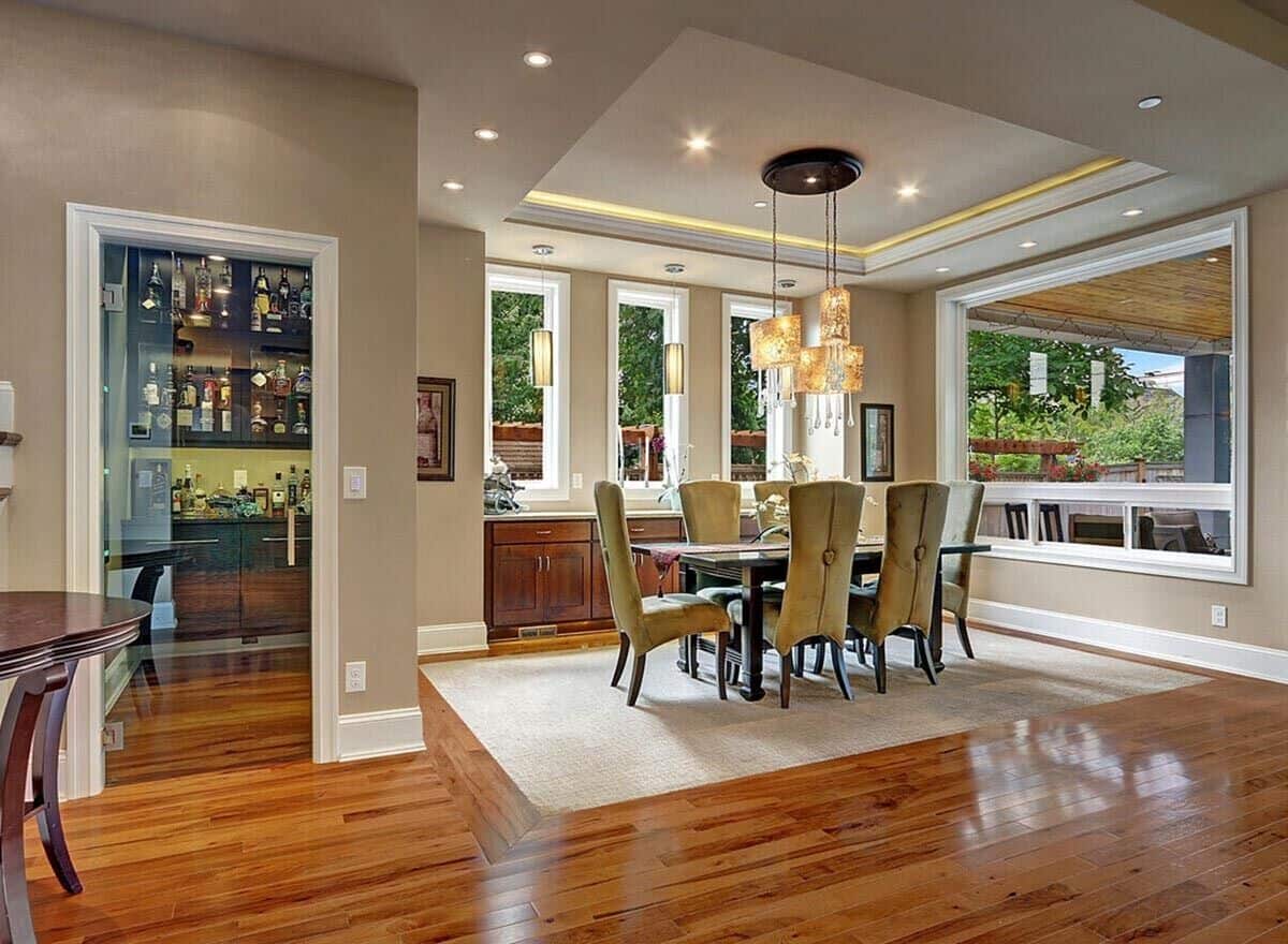 Dining area with a 6-seater dining set and a built-in buffet table under the picture windows.