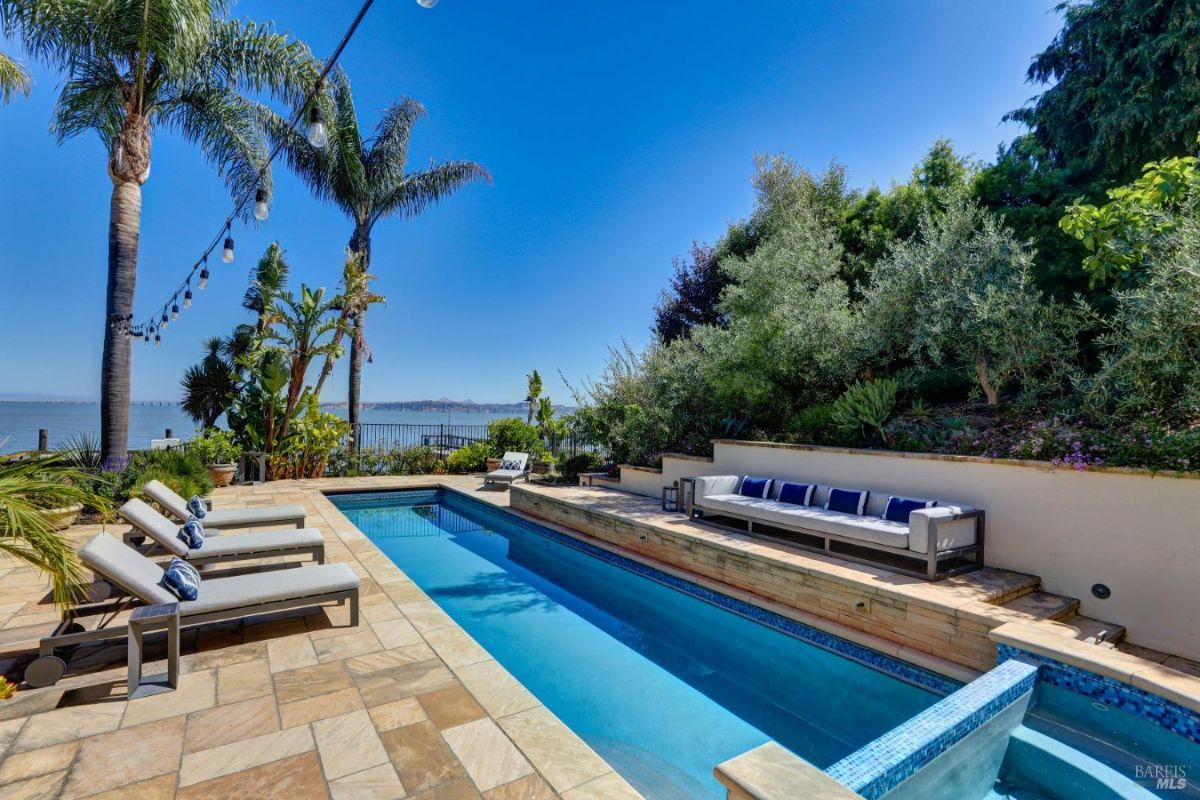 Pool with lounge chairs overlooking the bay.