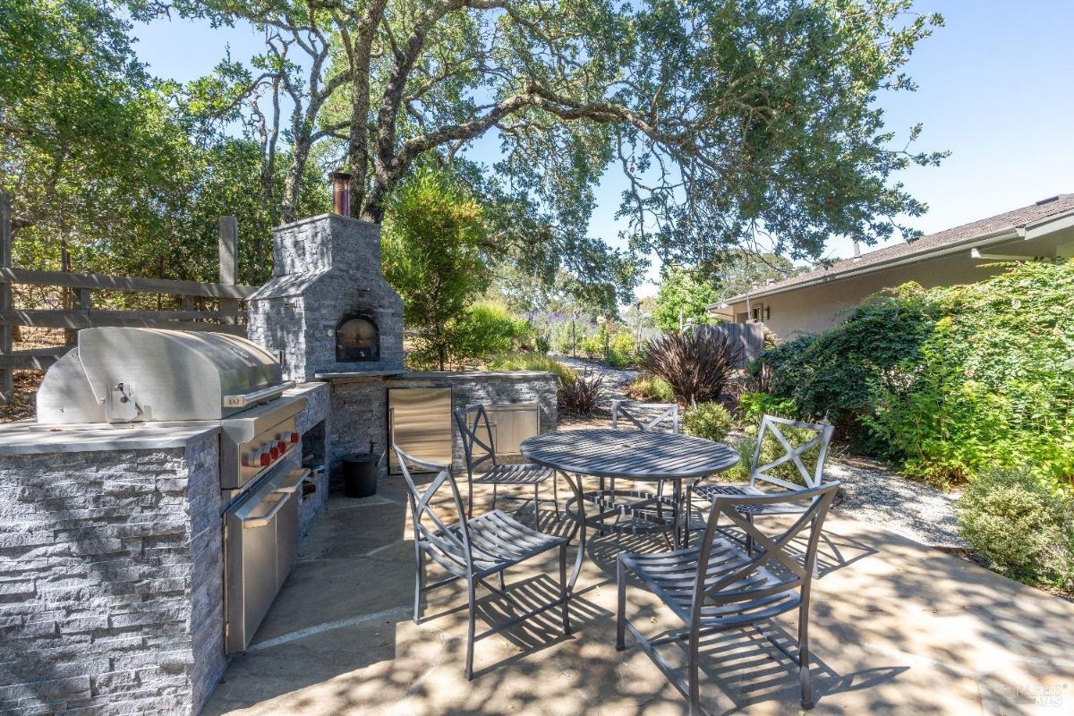 Grill area with a table and chairs.