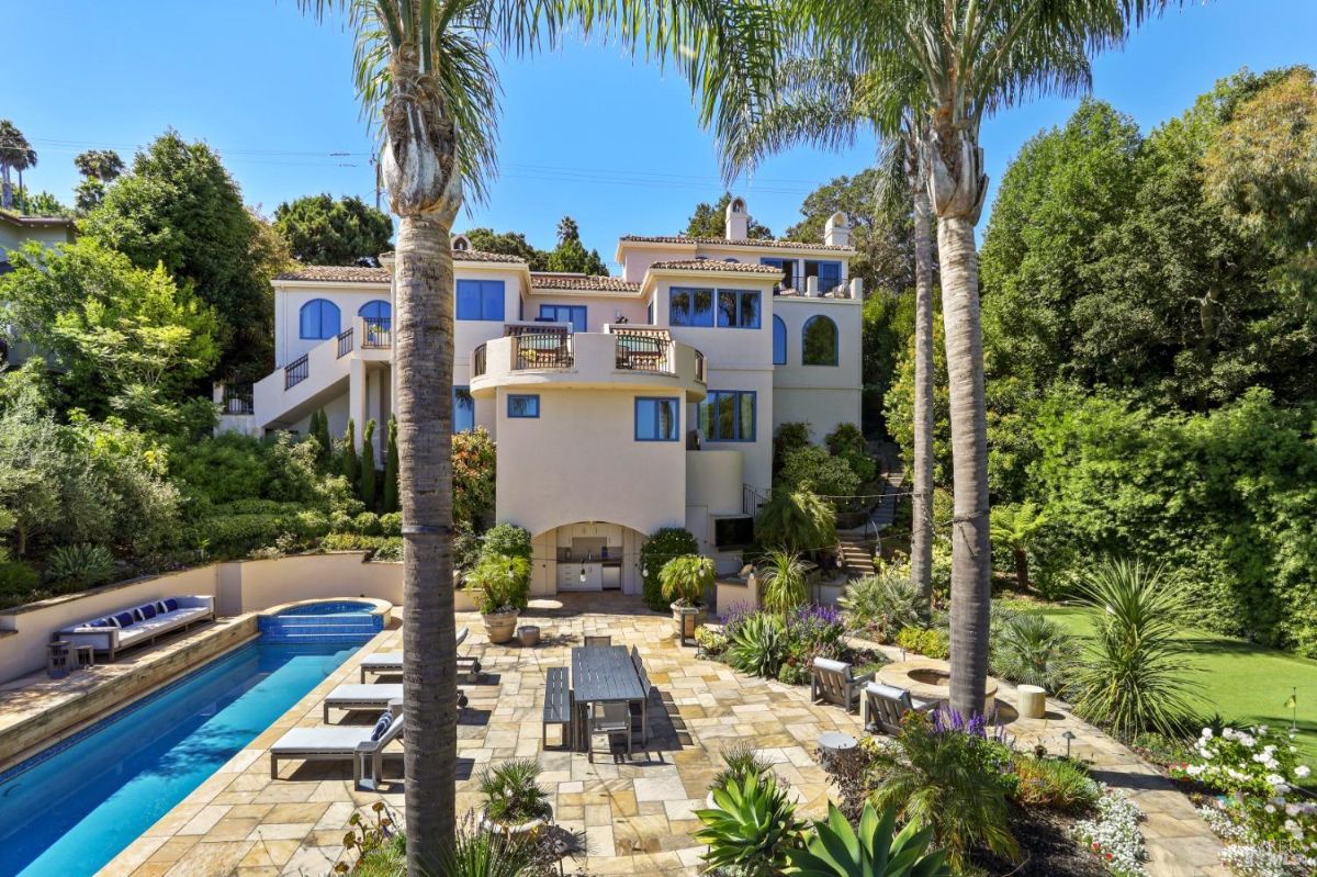 Rear view of the mansion with a pool.