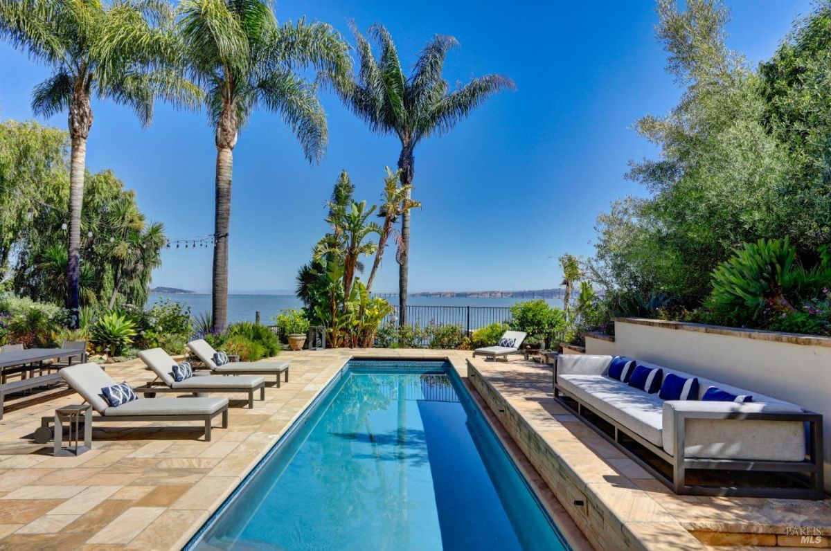 Pool with lounge chairs overlooking the bay.