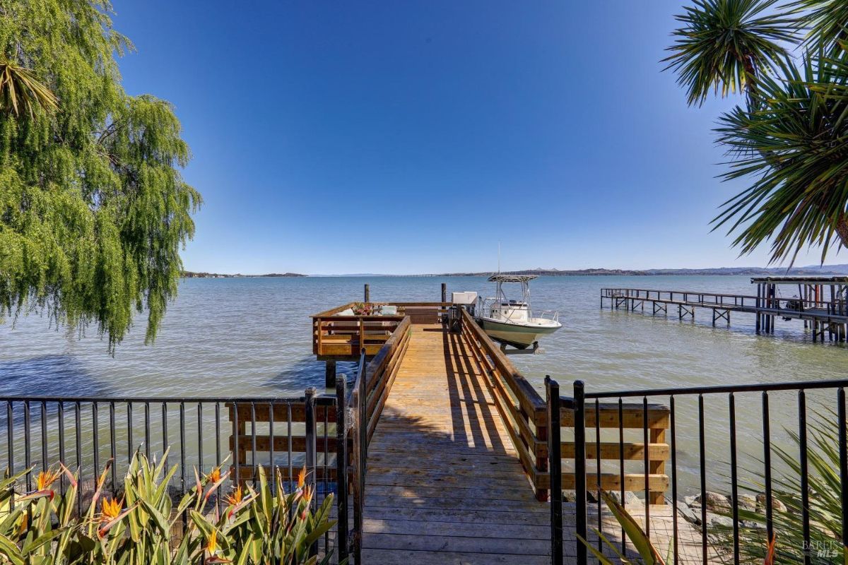 Boat dock with lounge area and boat lift.