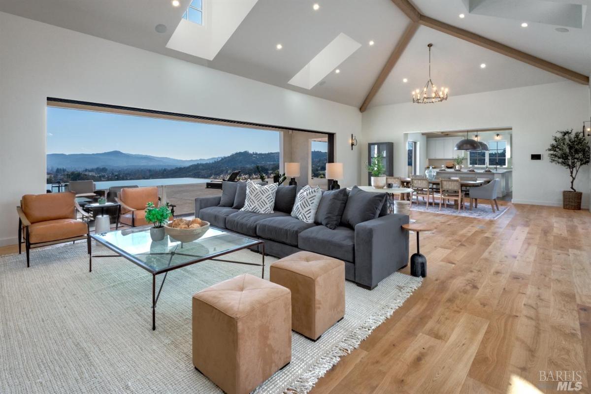 Living room with wood flooring and custom lights.