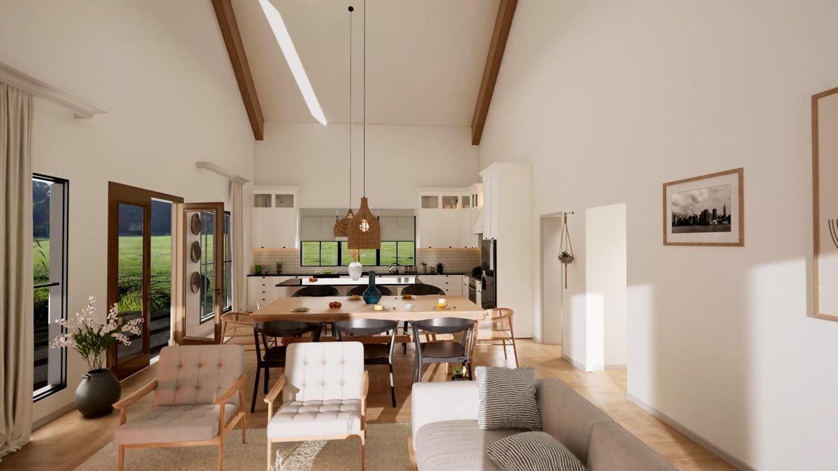 An open layout view of the great room, dining area, and kitchen under a vaulted ceiling.