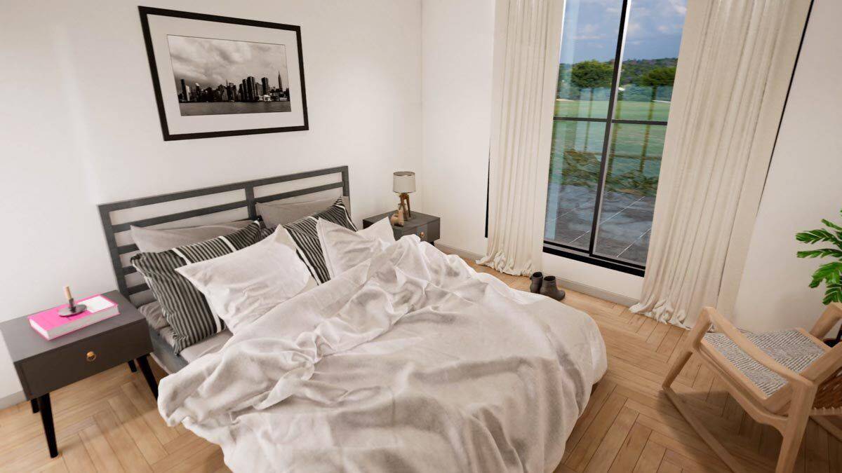 Secondary bedroom with a metal bed and wooden armchair over the parquet flooring.