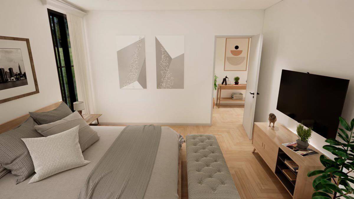 The primary bedroom includes a large TV mounted above the wooden console table.