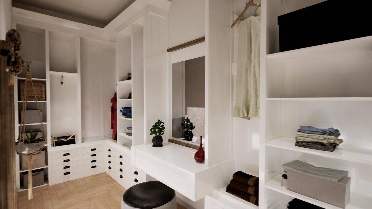 Primary walk-in closet with ample storage and a built-in vanity paired with a round stool.