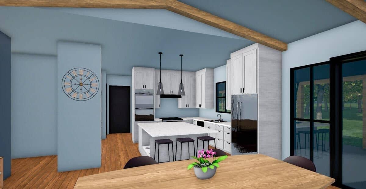 Dining area and kitchen with hardwood flooring and light blue walls.