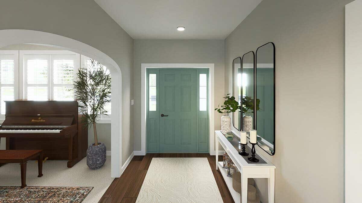 The foyer includes a sage green front door and an archway that opens to the den.