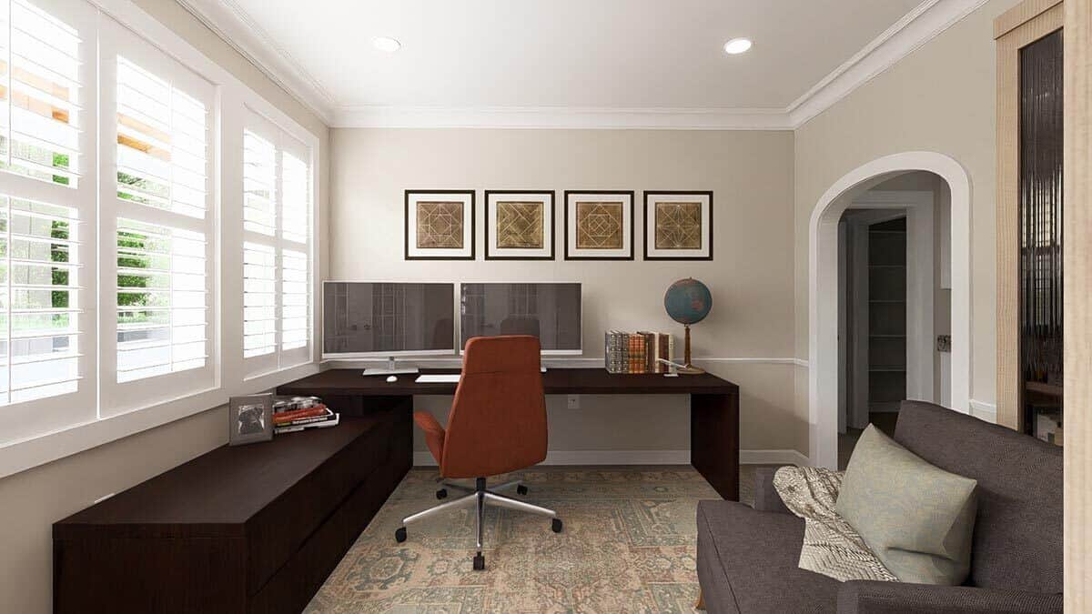 Home office with a gray sofa and a dark wood desk paired with a swivel chair.