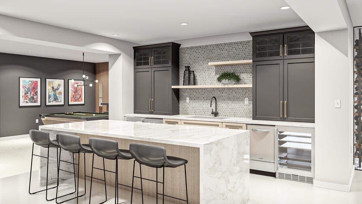 Wet bar with black and wooden cabinets, a sink, and a waterfall island lined with four bar stools.