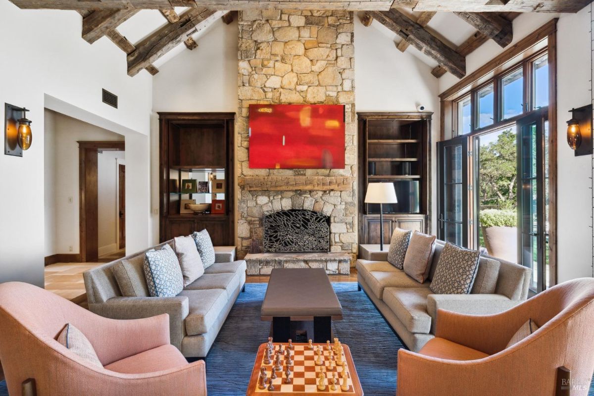 Living room with couches and a fireplace.