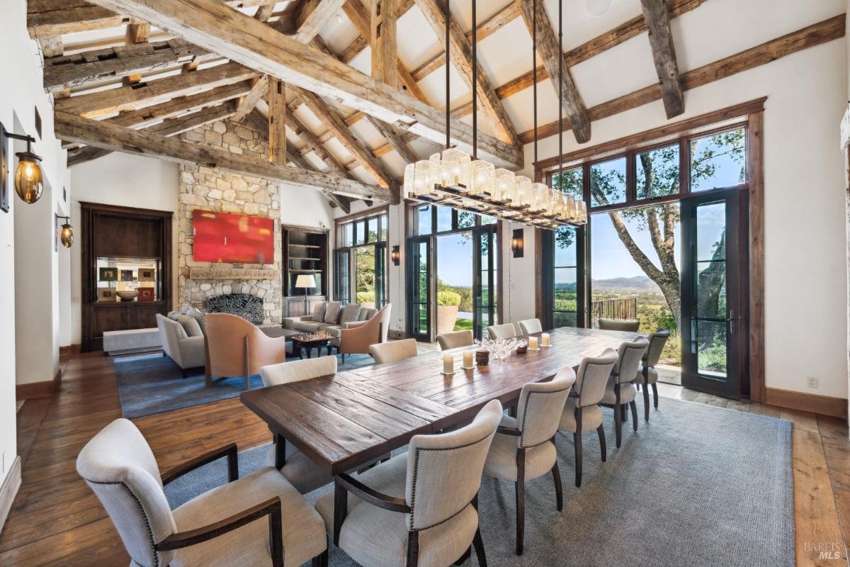 Dining room with a large wood table and chandelier.