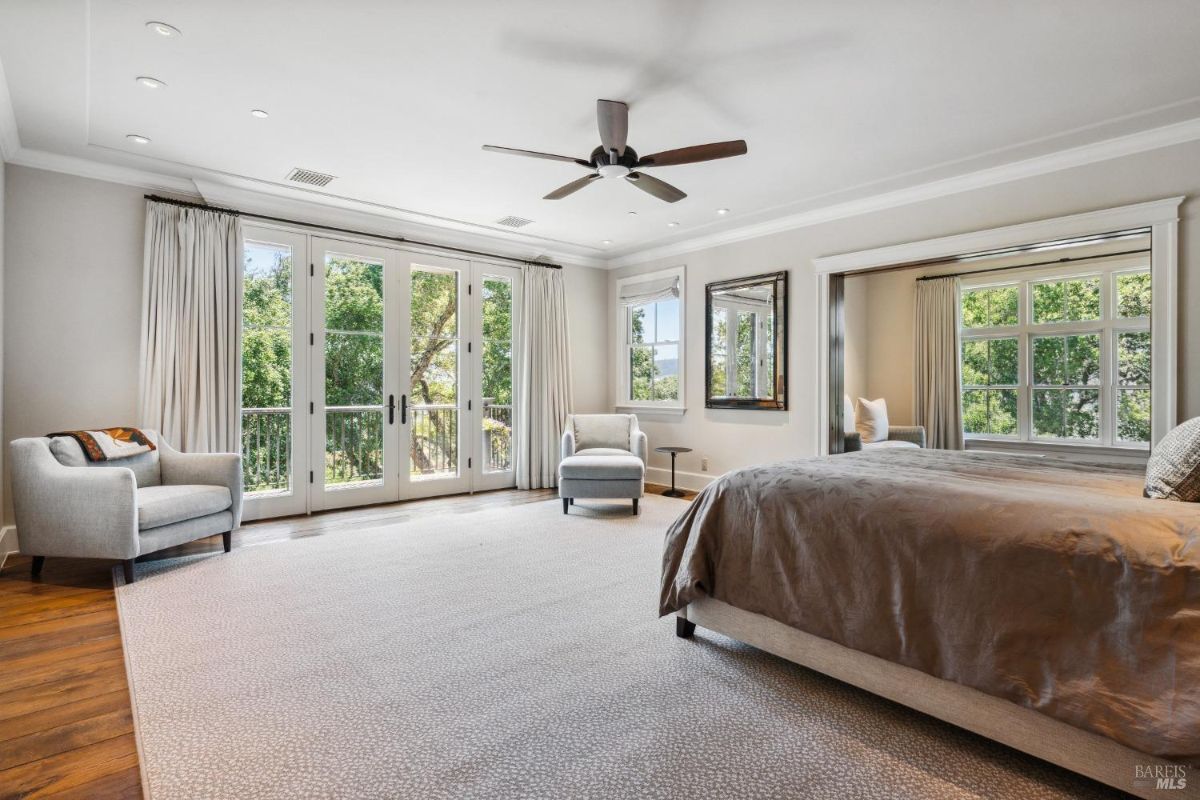 Bedroom with a large bed and glass doors.