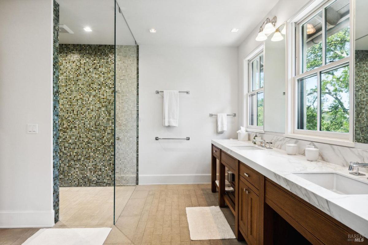 Bathroom with sinks and walk-in shower.