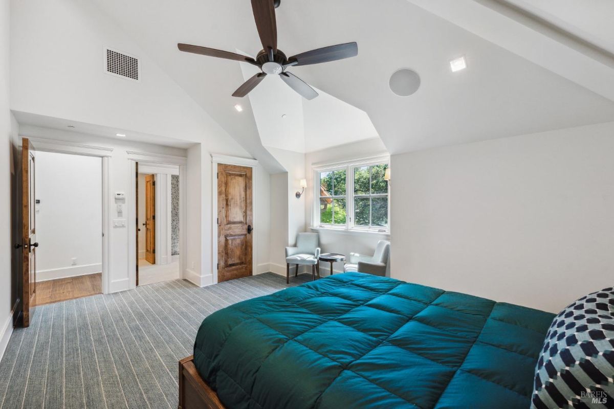 Bedroom with a large bed and glass windows.