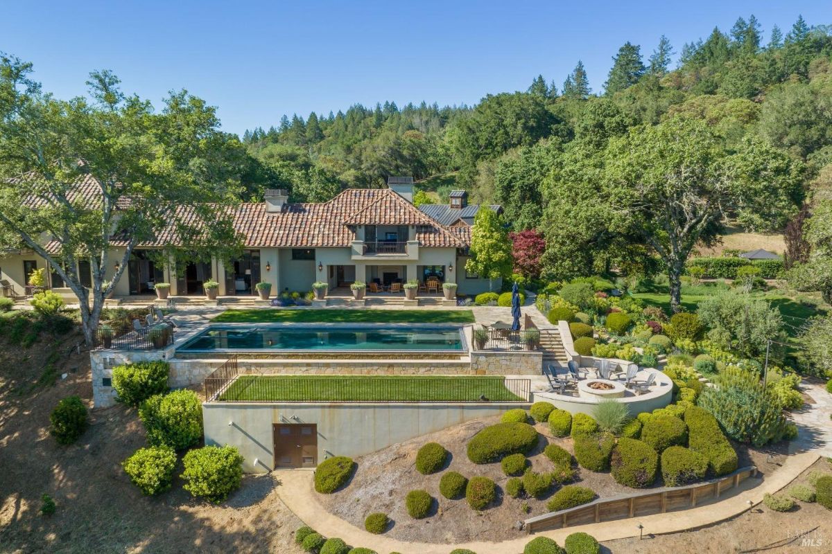 Aerial view of the mansion with a pool.